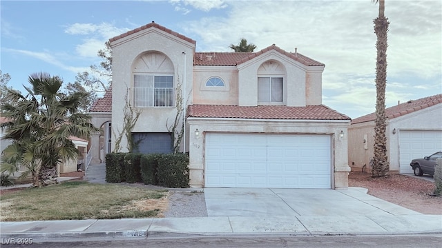 mediterranean / spanish-style house with a garage