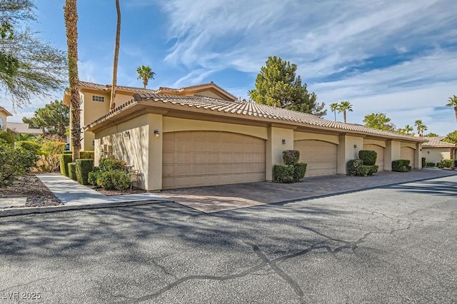 view of home's exterior with a tiled roof and stucco siding