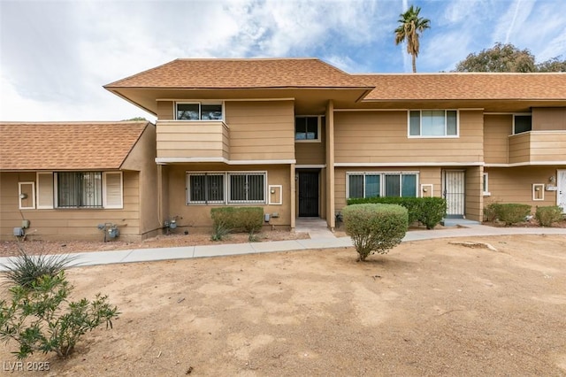 view of property with a shingled roof