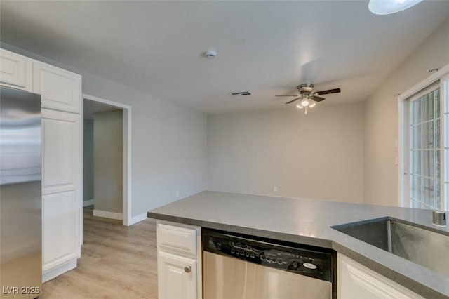 kitchen with stainless steel appliances, white cabinets, and a sink