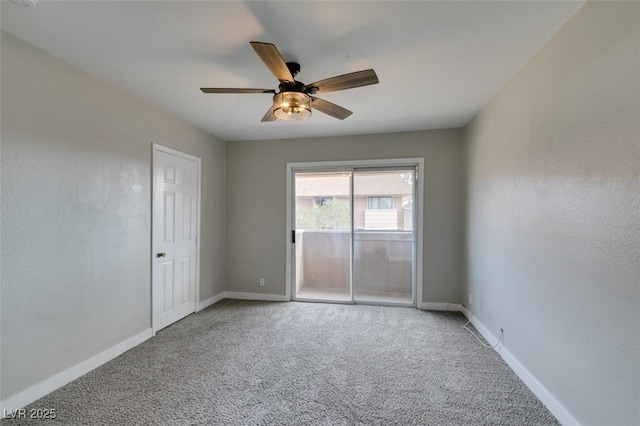 carpeted spare room featuring a ceiling fan and baseboards