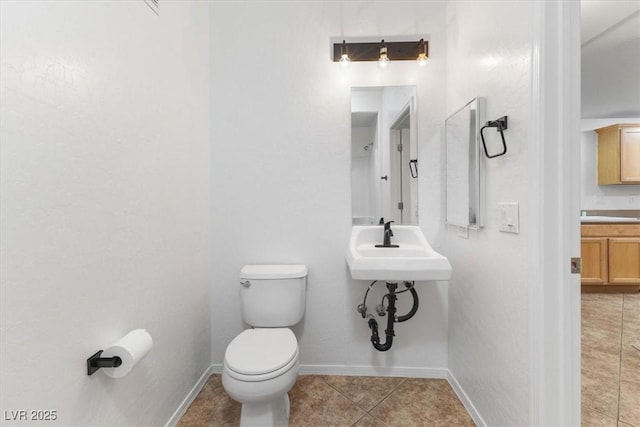 bathroom with tile patterned floors and toilet