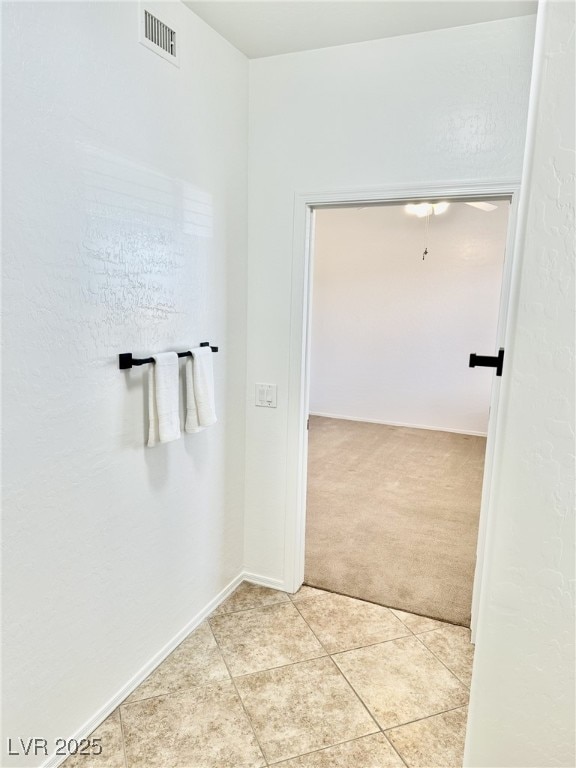 hallway with light tile patterned floors