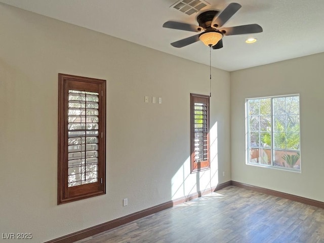 spare room with hardwood / wood-style flooring and ceiling fan