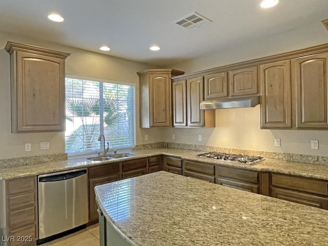 kitchen with sink, light tile patterned flooring, stainless steel appliances, and light stone countertops