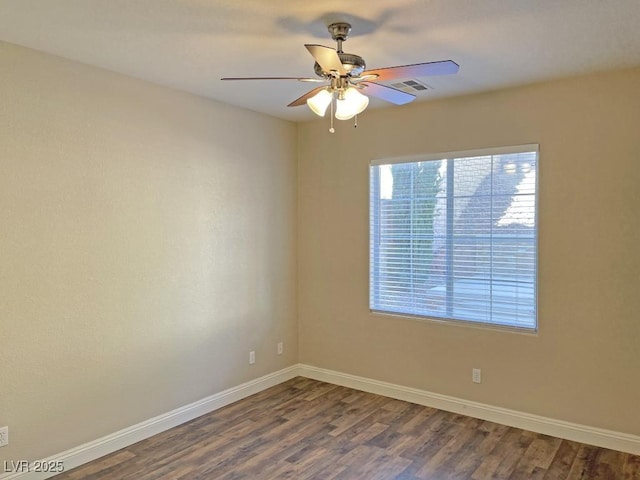 spare room with hardwood / wood-style floors and ceiling fan