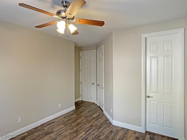 unfurnished bedroom with dark wood-type flooring, a closet, and ceiling fan