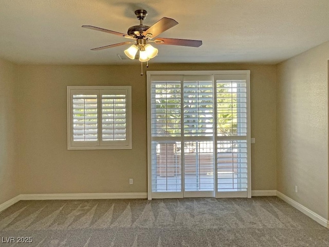 empty room featuring carpet floors and ceiling fan