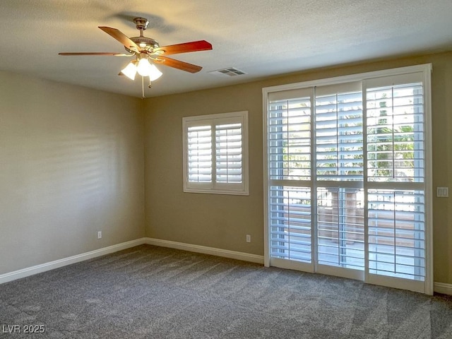 carpeted empty room with a textured ceiling and ceiling fan