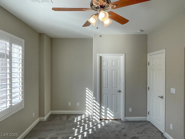 spare room with ceiling fan and carpet flooring