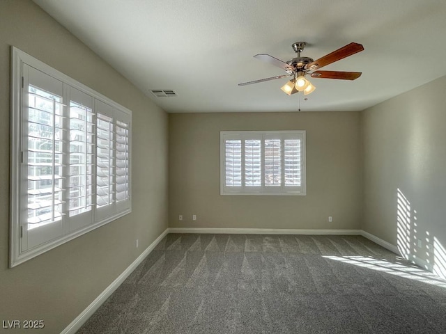 carpeted empty room featuring a healthy amount of sunlight and ceiling fan