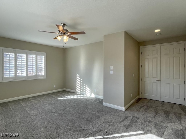 carpeted spare room with ceiling fan