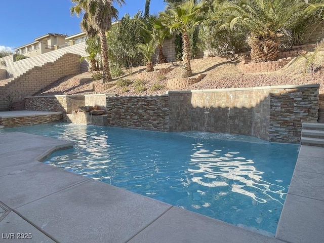 view of swimming pool with pool water feature