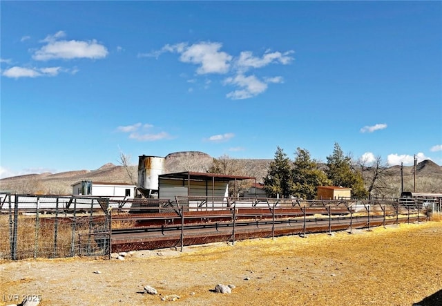 view of front of house featuring a rural view and a mountain view