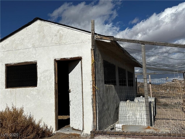 view of side of home featuring an outbuilding