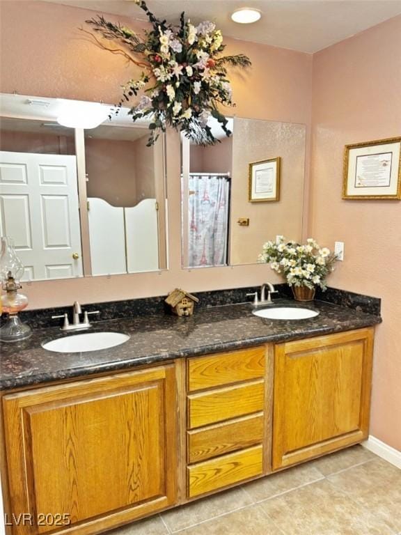 bathroom with vanity and tile patterned flooring