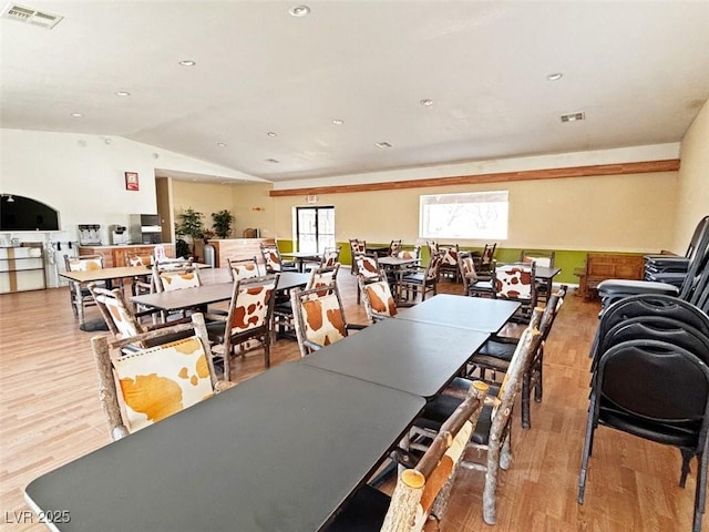 dining area with lofted ceiling and light hardwood / wood-style floors