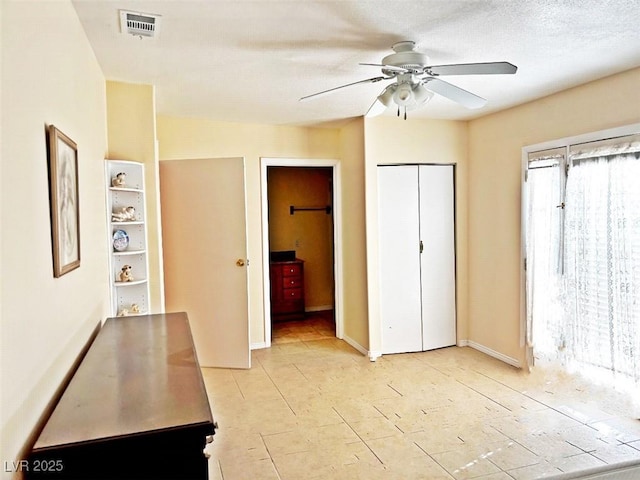 unfurnished bedroom with a textured ceiling and ceiling fan