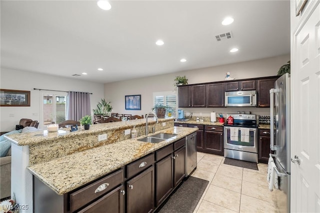 4459 Lavender, Pahrump, NV 89061 - kitchen featuring appliances with stainless steel finishes, light stone countertops, sink, and light tile patterned floors