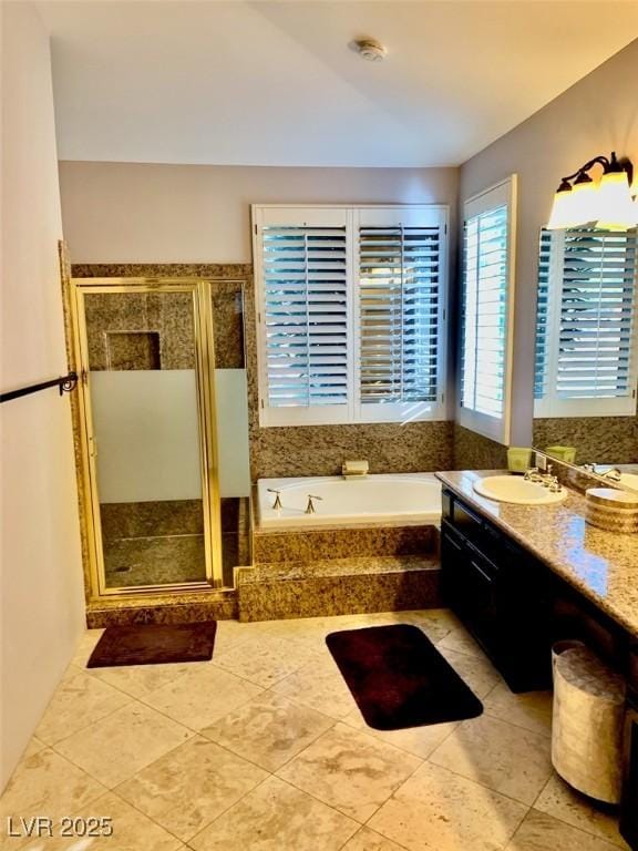 bathroom featuring tile patterned floors, vanity, and shower with separate bathtub