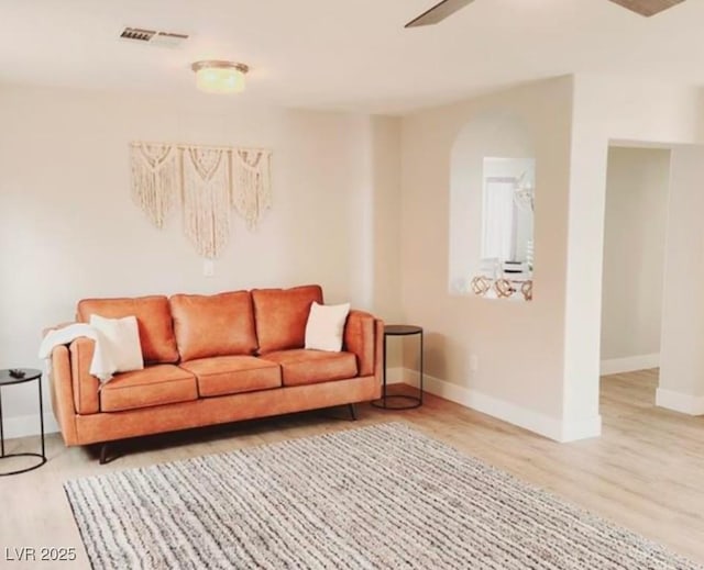 living room with hardwood / wood-style flooring and ceiling fan