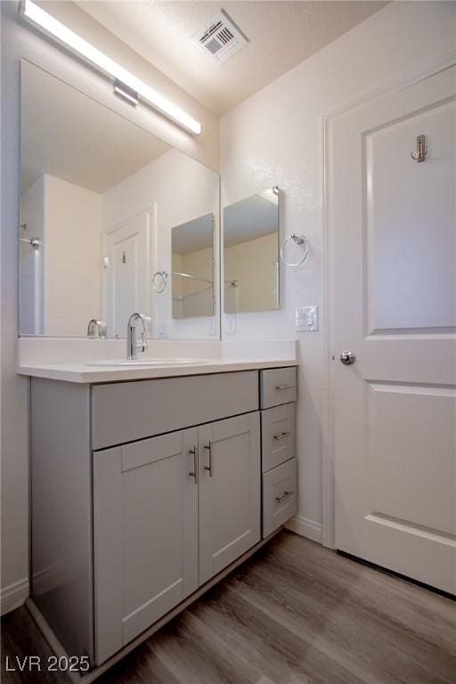 bathroom featuring vanity and wood-type flooring