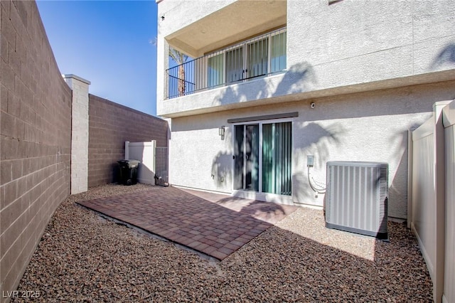 back of house with a patio area and central air condition unit