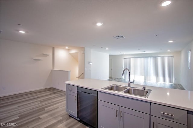 kitchen featuring light wood-type flooring, black dishwasher, sink, and gray cabinetry