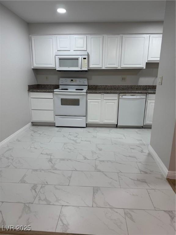 kitchen featuring white cabinets and white appliances