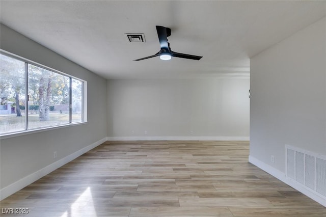 unfurnished room with ceiling fan and light wood-type flooring