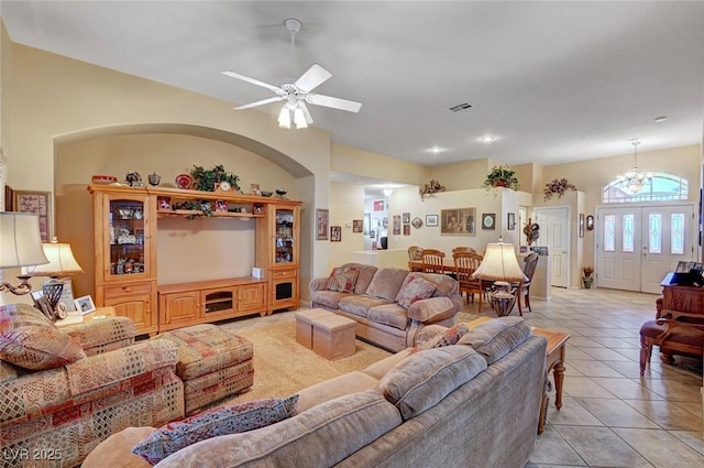 living room featuring ceiling fan with notable chandelier and light tile patterned floors