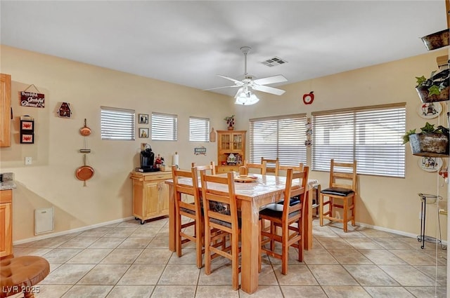 dining area featuring light tile patterned floors and ceiling fan