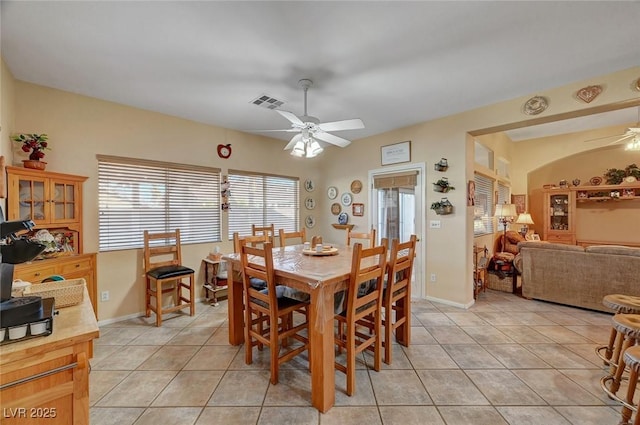 tiled dining space with ceiling fan