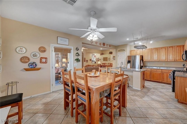 dining area featuring light tile patterned floors and ceiling fan