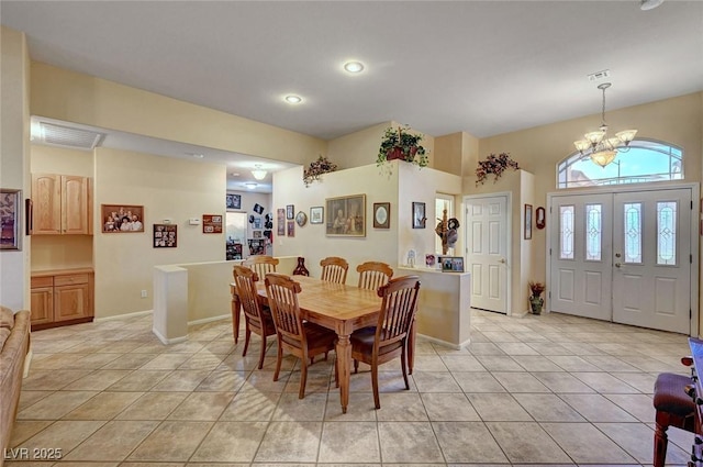 tiled dining room with a chandelier