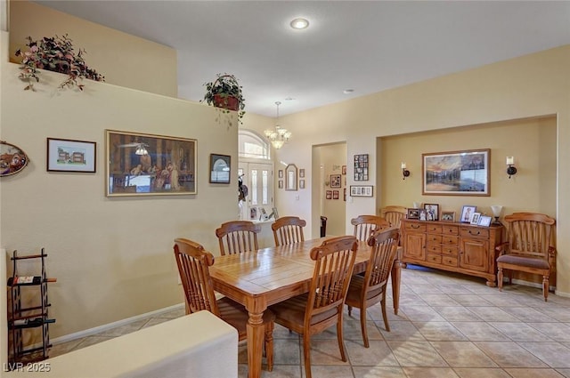 dining space with an inviting chandelier and light tile patterned flooring