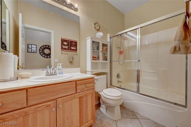 full bathroom with tile patterned flooring, vanity, toilet, and combined bath / shower with glass door