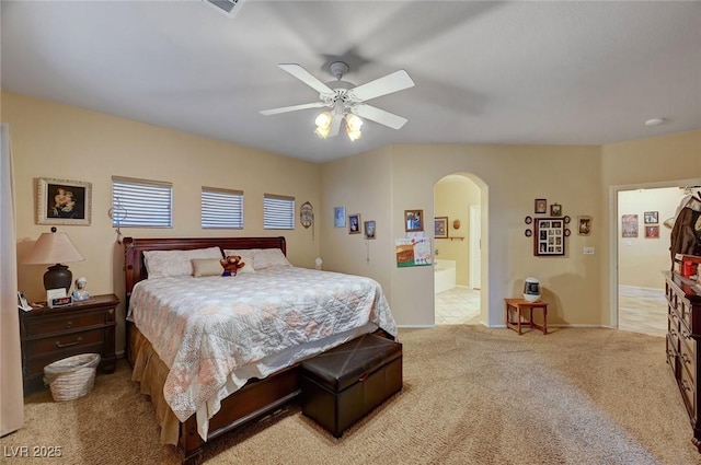 carpeted bedroom featuring ensuite bathroom and ceiling fan