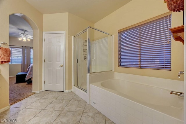 bathroom with tile patterned flooring, independent shower and bath, and ceiling fan