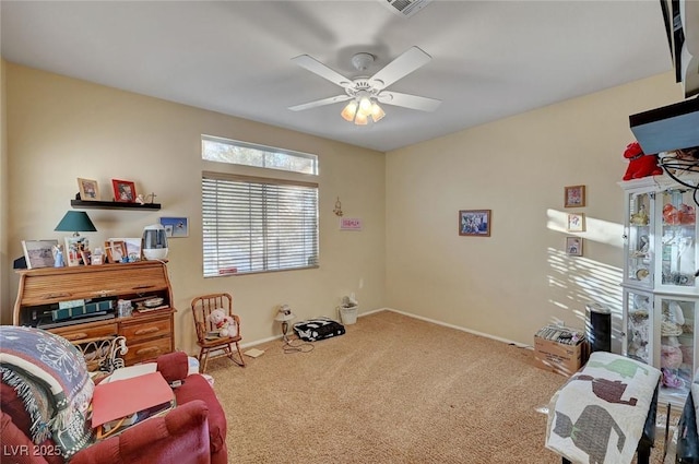 living area featuring carpet flooring and ceiling fan