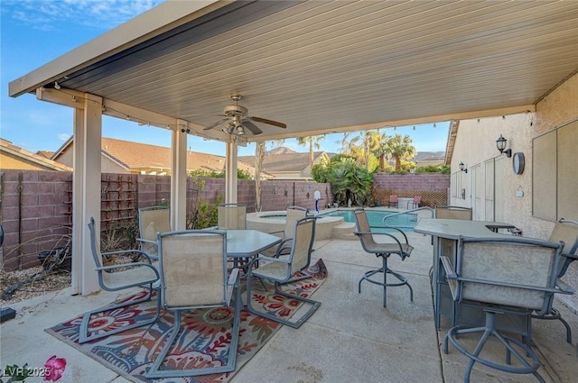 view of patio / terrace featuring a swimming pool with hot tub, a mountain view, and ceiling fan