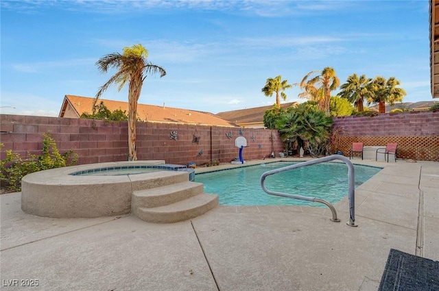 view of pool featuring a patio area and an in ground hot tub