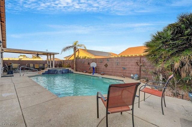 view of pool featuring a patio area and an in ground hot tub