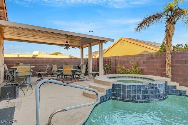 view of swimming pool featuring an in ground hot tub, ceiling fan, and a patio area