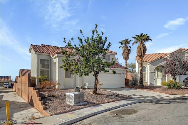 2573 Rafferty Creek Ln, Las Vegas, NV 89156 - mediterranean / spanish-style home with concrete driveway, stucco siding, a tiled roof, a garage, and fence