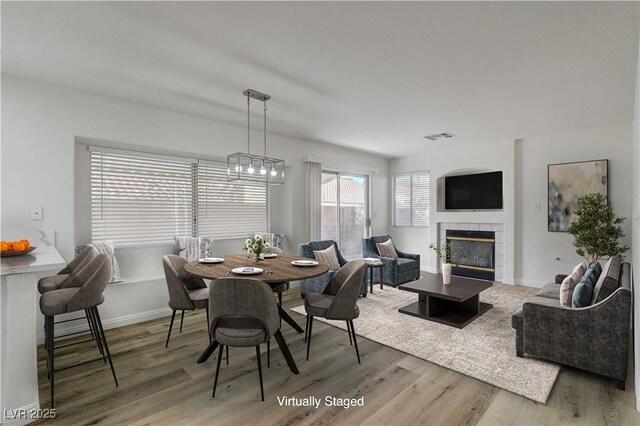 2573 Rafferty Creek Ln, Las Vegas, NV 89156 - dining area featuring wood finished floors, a fireplace, and baseboards