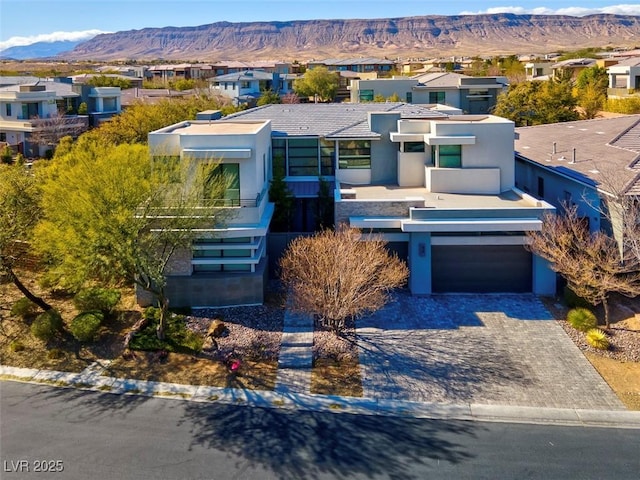 view of front facade featuring a garage and a mountain view