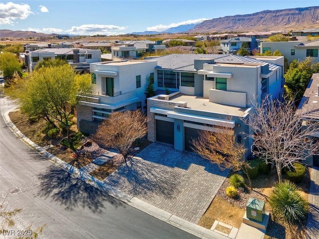 view of front facade featuring a garage and a mountain view