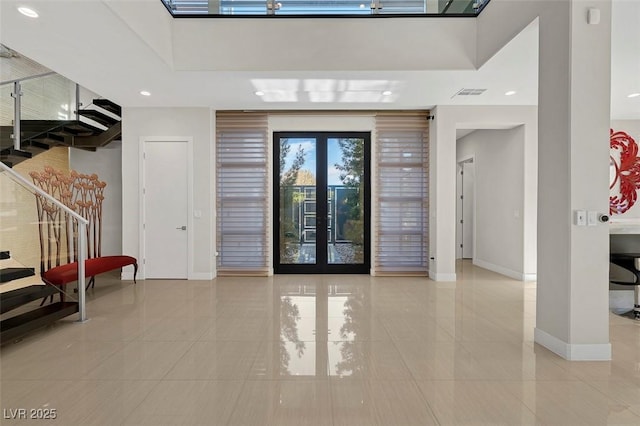 foyer entrance featuring french doors and a high ceiling