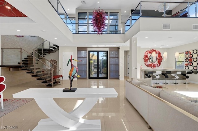 interior space featuring a high ceiling and french doors